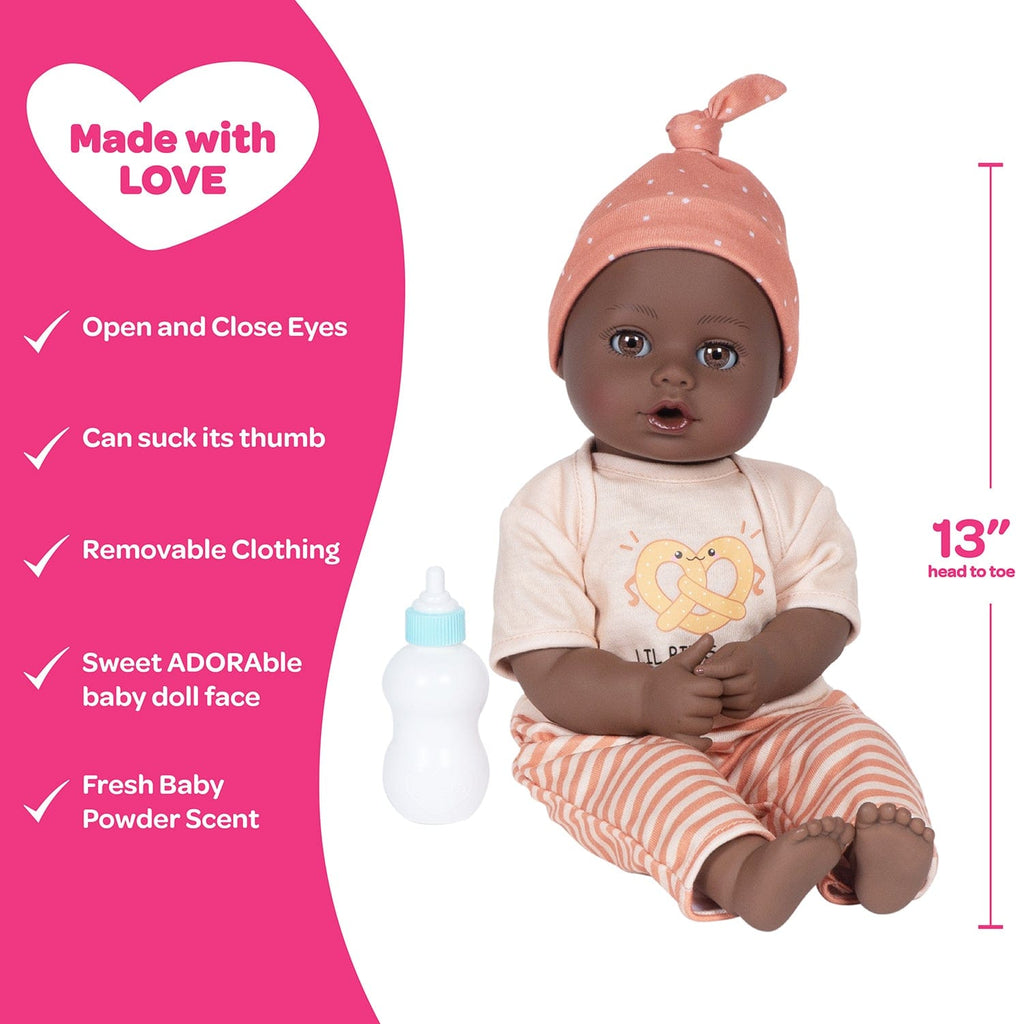 Adora Sweet Pretzel baby doll set includes one 13-inch African American doll, pretzel-printed shirt, pants, matching beanie, blue baby bottle.  Made for Ages 1+.