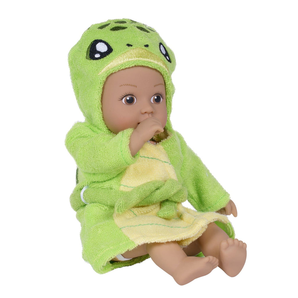 Adora BathTime baby doll set comes with one 8.5-inch baby doll boy, an attached sandy-colored sea turtle-print swimsuit, and an embroidered hooded Sea Turtle terry bathrobe complete with an embroidered face and green turtle shell on the back. 100% machine washable - made to love and last with Adora's exclusive Quick Dry fabric. 