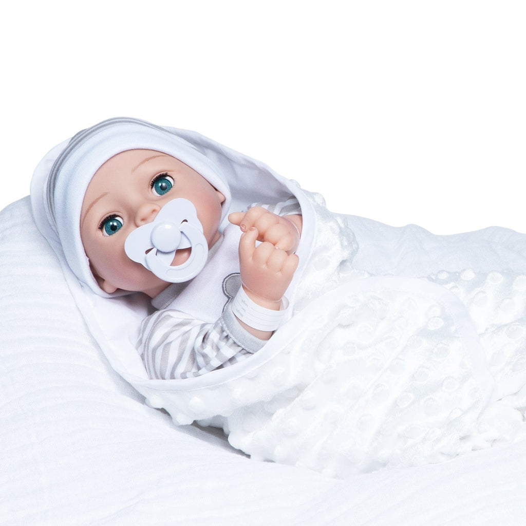 Gender-neutral baby doll set comes with one 16" weighted baby doll, a Certificate of Adoption, a pacifier, a hospital bracelet, a disposable diaper, a baby blanket, a crib, and a removable striped, cloud-print onesie with a matching cap.